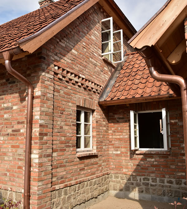 Englisches Landhaus mit Klinkerfassade und Natursteinsockel, sowie den typischen Sprossenfenstern - Bauunternehmen Alan Berry aus Celle, ihr Maurer für englische Cottages und Landhäuser in Celle. Nachhaltiger Hausbau mit historischen Baustoffen. Typische Sprossenfenster, Klinkerfassade und Natursteinsockel - Englische Cottages aus Celle - Bauunternehmen Alan Berry